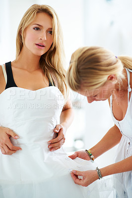 Buy stock photo Shopping, wedding dress or woman helping a customer in retail boutique dressing room for size. Bride fitting, women or sales assistant with support, fabric or clothing for marriage or fashion style
