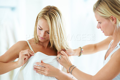 Buy stock photo Bride, wedding or woman helping with dress in dressing room for special day or event in Australia. Women, friends or bridesmaid with support or fabric or silk clothing for beauty, marriage or fashion
