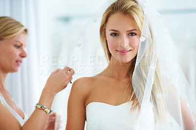 Buy stock photo A young woman trying on wedding dresses in a bridal boutique