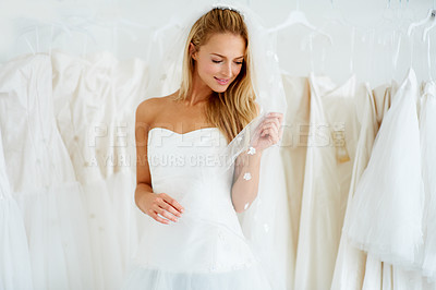 Buy stock photo A young bride trying on her wedding dress - Copyspace