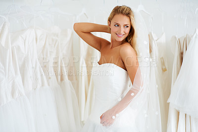 Buy stock photo A young bride trying on her wedding dress - Copyspace