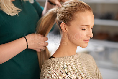 Buy stock photo A young woman getting her hair done