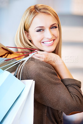 Buy stock photo Fashion, sale and shopping woman or customer is happy and excited holding bags at a store. Discount, offer and deal for smiling female in retail shop at the mall spending money on style at an outlet