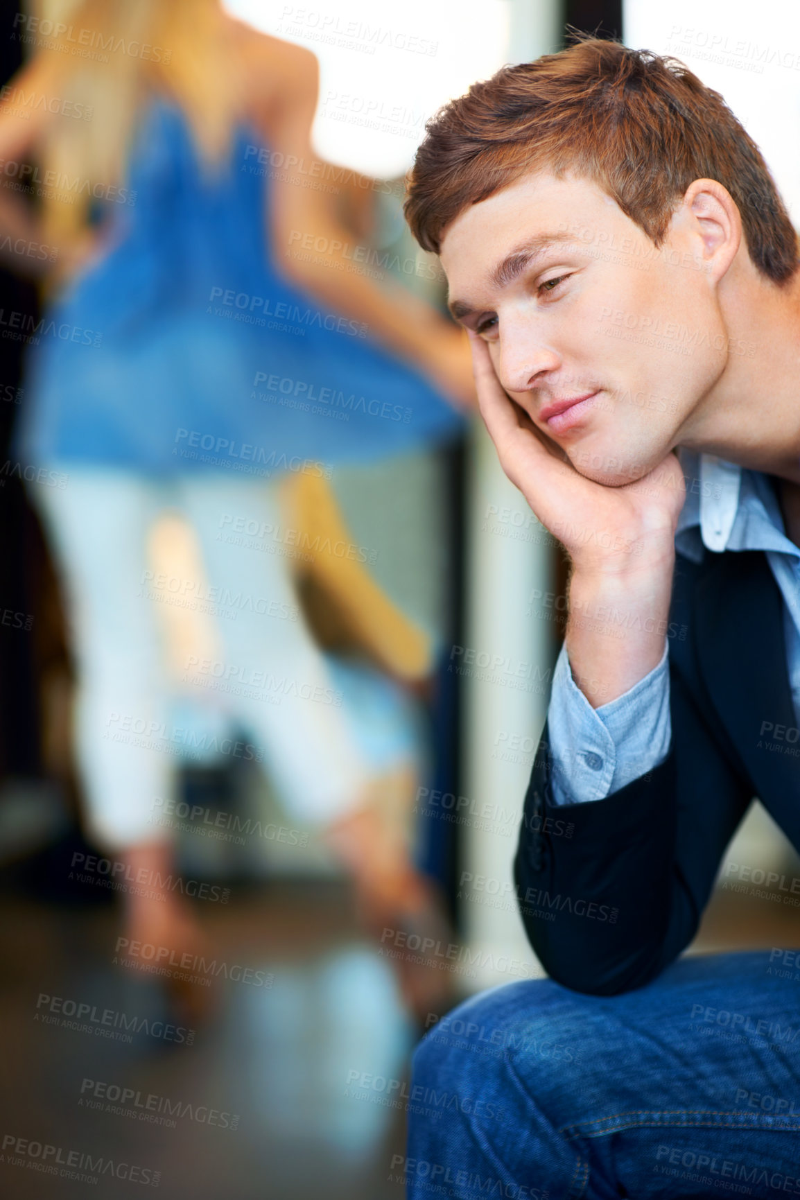 Buy stock photo Fashion, retail and store with a tired man waiting for a woman while shopping in a clothing boutique. Patient person almost sleeping in a retail store while female consumer is spending money and cash