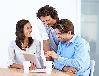 Buy stock photo Happy business people, tablet and laughing in meeting for funny joke or meme together at office desk. Group of friendly employees working on technology with laugh for social media or team building