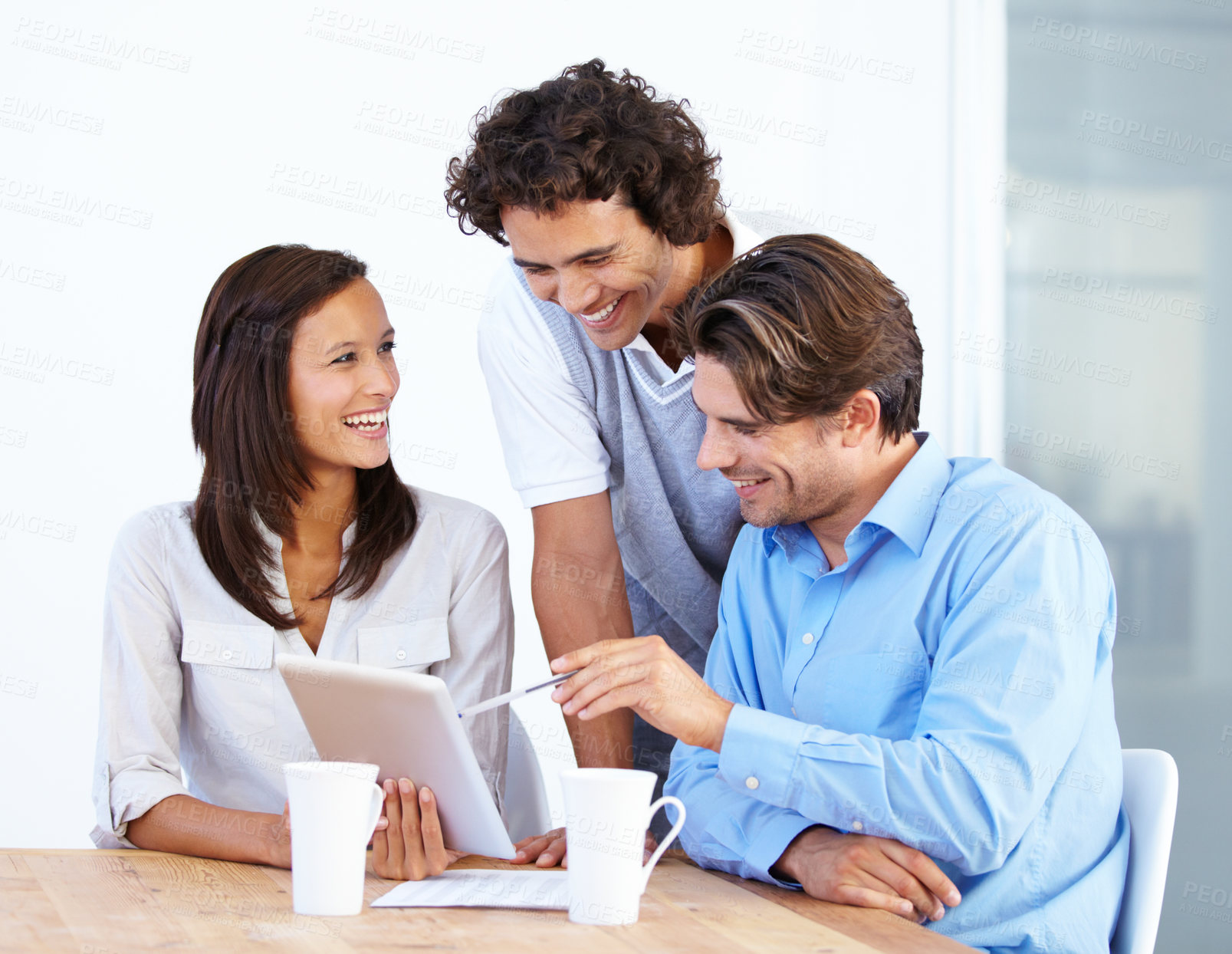 Buy stock photo Happy business people, tablet and laughing in meeting for funny joke or meme together at office desk. Group of friendly employees working on technology with laugh for social media or team building