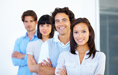 Buy stock photo A group of successful young entrepreneurs standing in a line together
