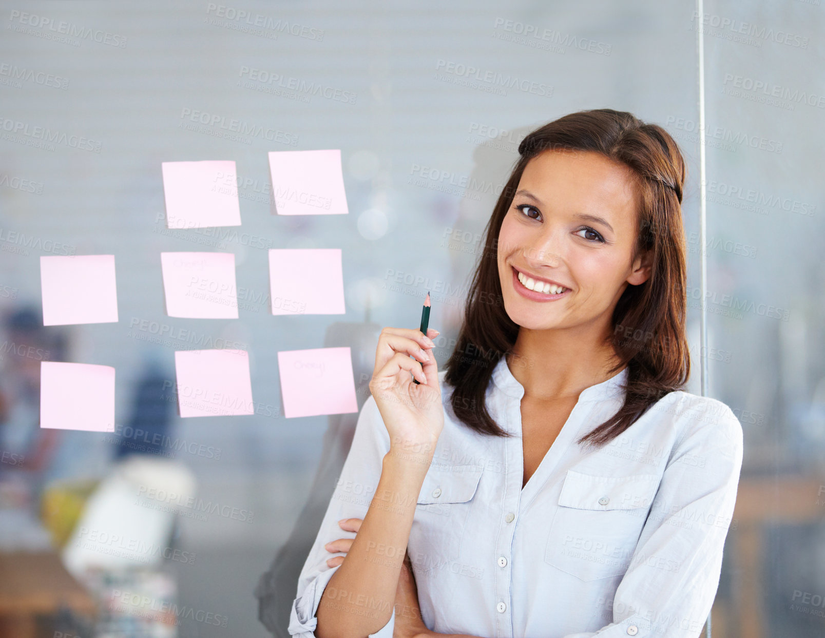 Buy stock photo A beautiful businesswoman delegating roles