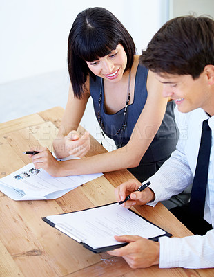 Buy stock photo A happy businessman and businesswoman working together in the office