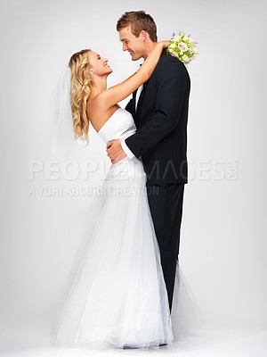 Buy stock photo Happy couple hug after wedding against a studio mockup background with a smile and bouquet. Romantic young man and woman dancing with fashion, elegant and fancy suit and dress after marriage event