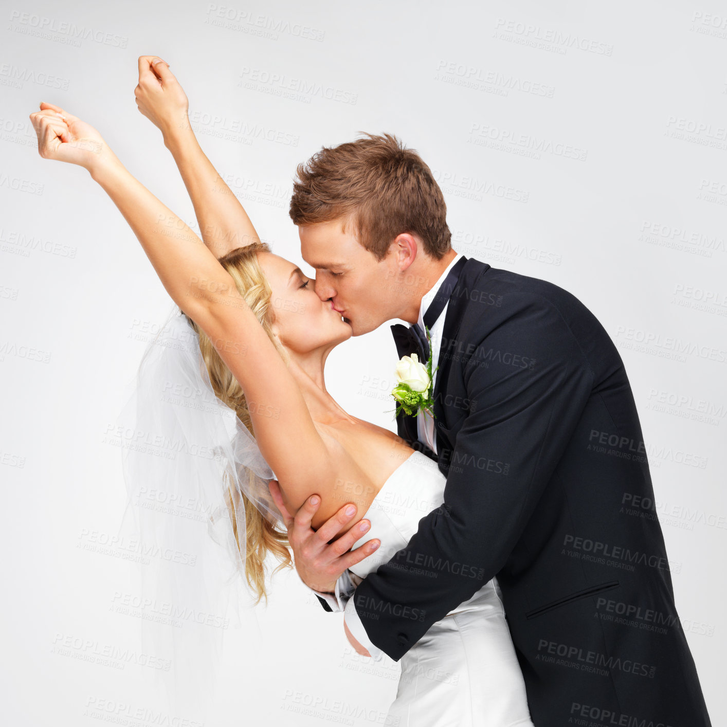 Buy stock photo Love, wedding and happy couple kiss at their marriage reception on a white studio background. Man, woman or bride and groom in celebration of their commitment, union or luxury romantic event