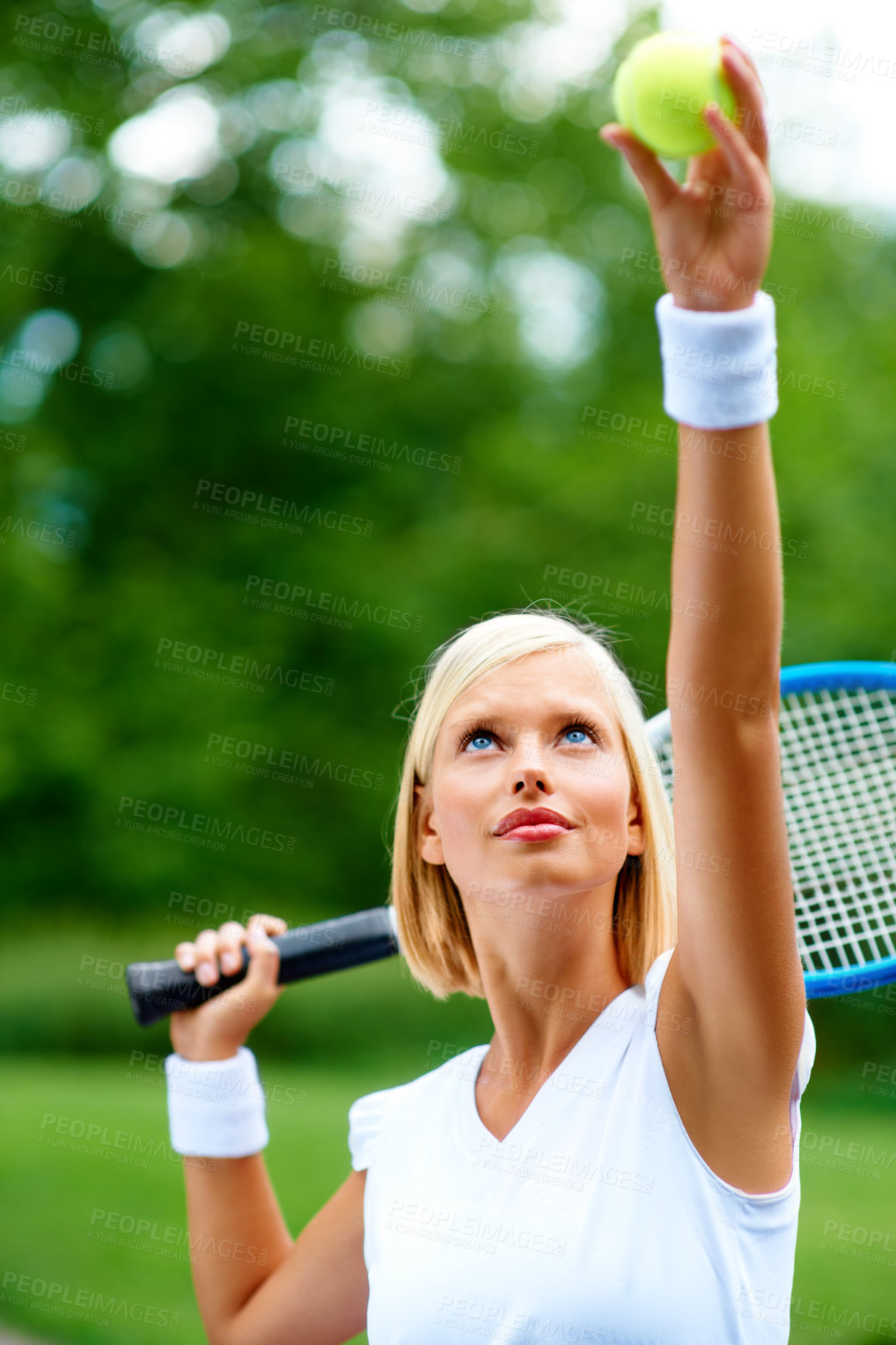 Buy stock photo A young female tennis player getting ready to serve the ball