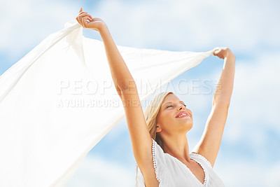 Buy stock photo A beautiful young woman holding a scarf in the breeze
