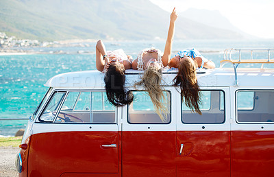 Buy stock photo Talking, travel or friends on beach or road trip for a summer holiday vacation together speaking to relax. Women lying, pointing or people on roof of van talking on a fun adventure break for freedom