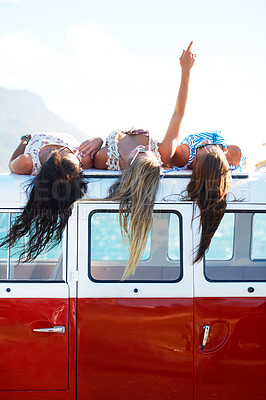 Buy stock photo Three young girls rest on top of their van looking at the sky - copyspace