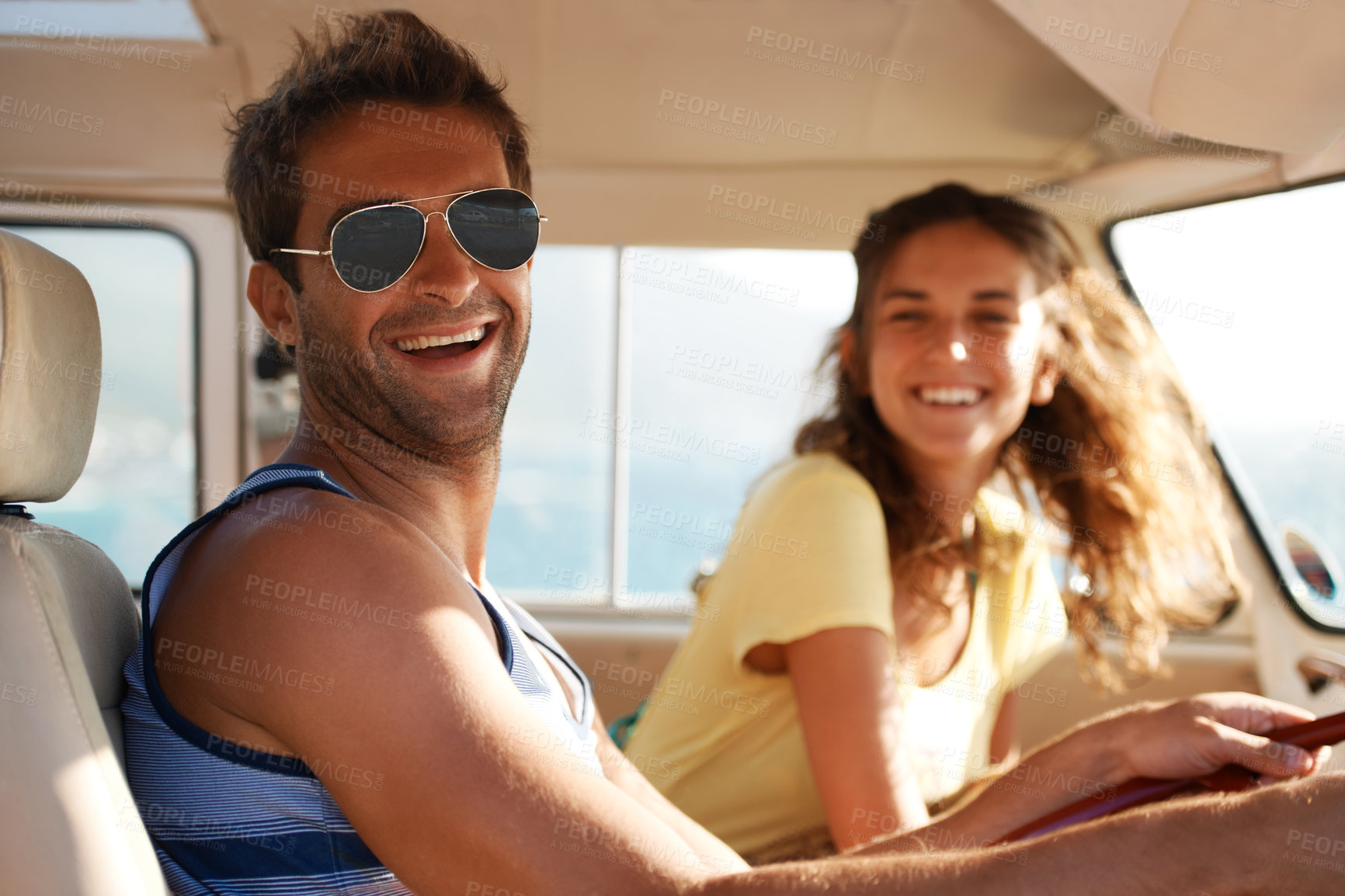 Buy stock photo Handsome male wearing glasses smiling and laughing with his girlfriend in the background