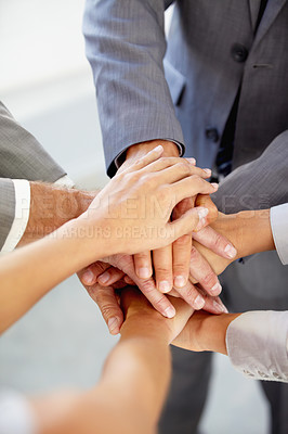 Buy stock photo Hands, collaboration and a business team in a huddle at the office together from above for unity or solidarity. Teamwork, support or circle with an employee group of men and woman in a workplace