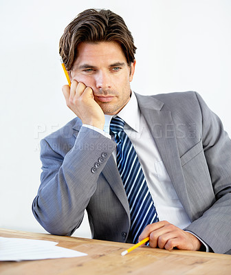 Buy stock photo Bored young businessman sitting at his desk 