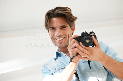 Buy stock photo Pride, camera and portrait of man photographer at a photoshoot for creative work project. Happy, photography and handsome young male person with dslr device for art career by white studio background.