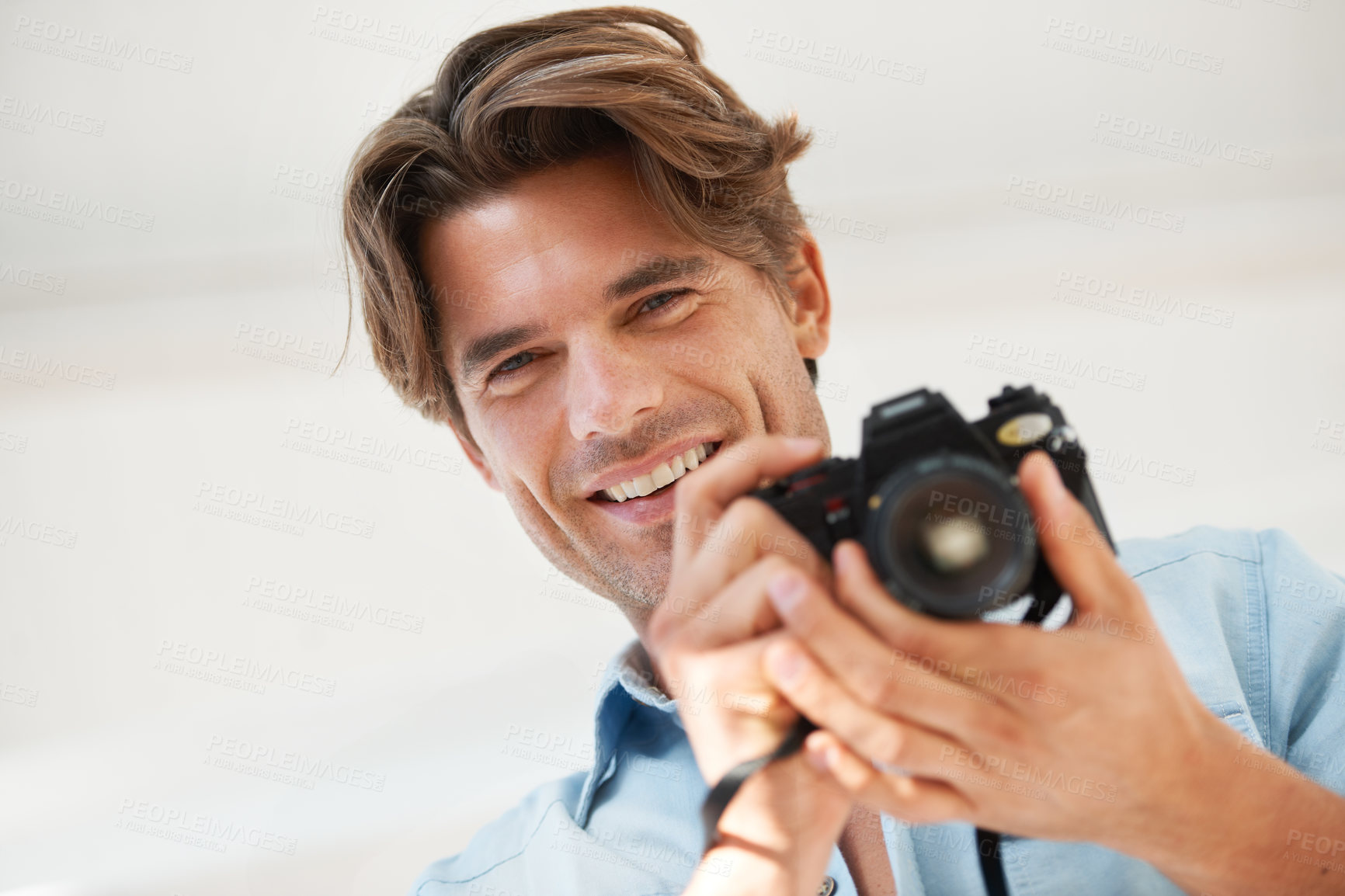 Buy stock photo Production, camera and portrait of man photographer at a photoshoot for creative work project. Happy, photography and handsome young male person with dslr device for art career by white background.