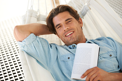 Buy stock photo Man in hammock , portrait and smile, reading book and relax, vacation and learning with self care and time alone. Knowledge, literature and novel with happiness, cozy and comfort, leisure or hobby