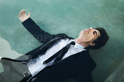 Buy stock photo Water, unemployment and a business man in debt during depression of the economy or financial crisis. Finance, pool and challenge with a young corporate employee wet in a suit for recession from above