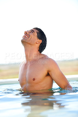 Buy stock photo Rooftop, pool and happy man swimming outdoor for travel, freedom or summer holiday at a resort. Smile, water and face of male swimmer in nature for luxury getaway at a villa, spa or hotel on vacation