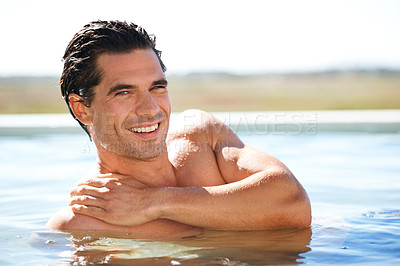 Buy stock photo Infinity pool, portrait and happy man swimming outdoor for travel, freedom or summer holiday at resort. Relax, smile and face of male swimmer in nature for luxury getaway at villa, spa or hotel trip
