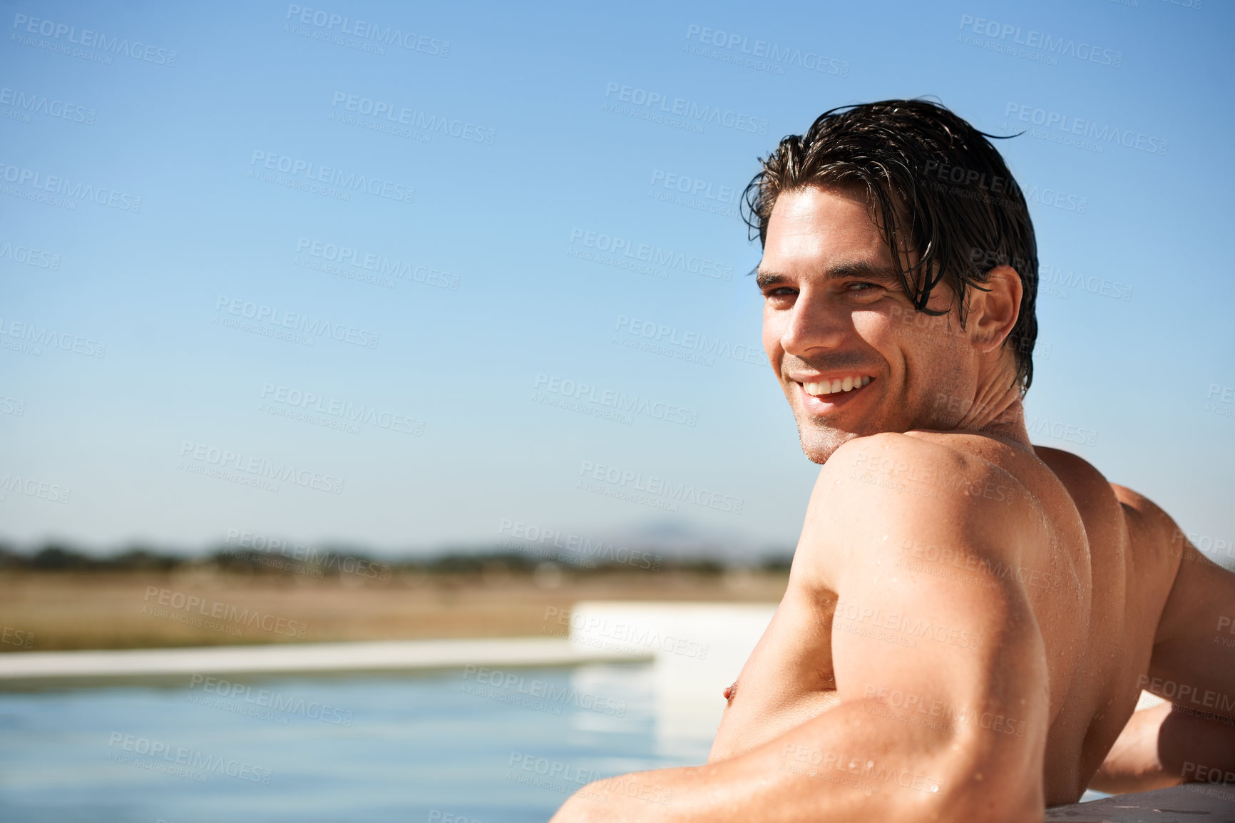 Buy stock photo Portrait, infinity pool and happy man swimming outdoor for travel, freedom or summer holiday at resort. Relax, smile and face of male swimmer in nature for luxury getaway at villa, spa or hotel trip