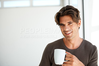 Buy stock photo Portrait, smile and man with coffee in home for breakfast, warm beverage or relax in morning with mockup space. Happy guy enjoy drinking mug of fresh caffeine, cappuccino or hot espresso in apartment