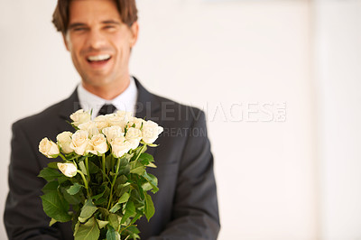 Buy stock photo Portrait, gift and happy man with flowers for love, giving or valentines day celebration on wall background. Face, roses and person with bouquet for anniversary, romance or congratulations gesture