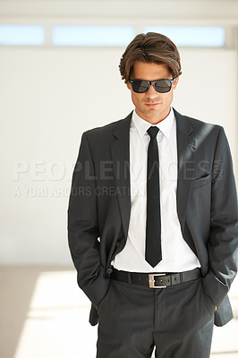 Buy stock photo Attitude, confident and business man in office with glasses, attitude or empowered on wall background. Leader, mindset and cool male entrepreneur stylish, edgy and posing with leadership or focus