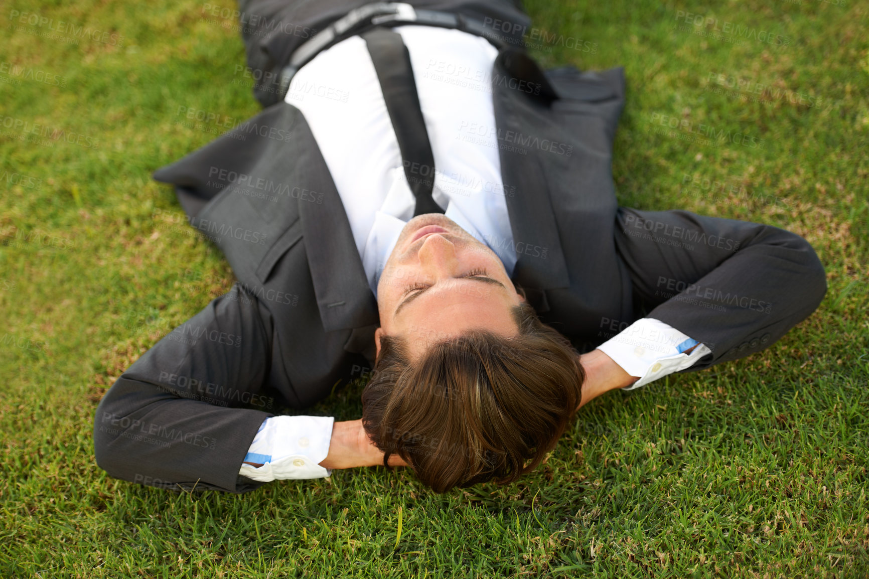 Buy stock photo Relax, grass and a business man lying on a field outdoor from above for the success of a completed task. Sleep, dreaming or rest with a corporate employee chilling at a garden or park in summer