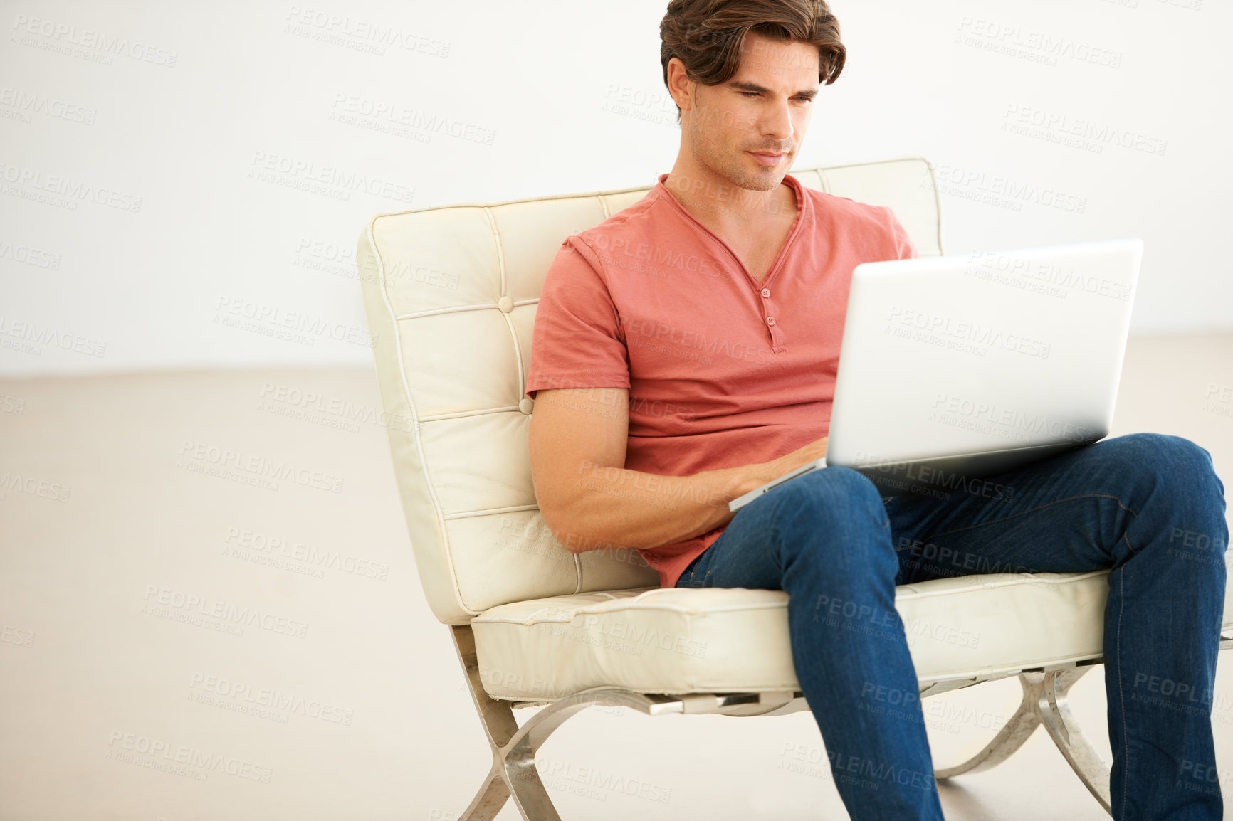 Buy stock photo Man, remote work and typing with laptop on couch for social media, digital network and online shopping. Serious freelancer on computer for reading email, website article and research in modern house 