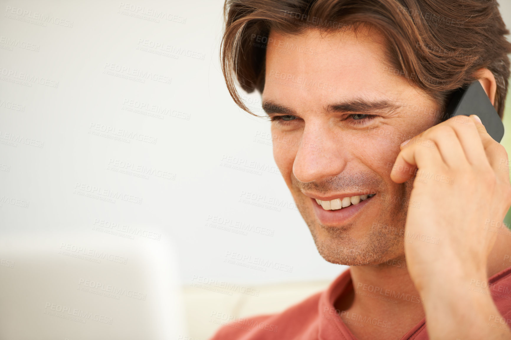 Buy stock photo Phone call, smile and young man in discussion for communication with technology at home. Happy, networking and male person from Canada on mobile conversation with cellphone relaxing at apartment.