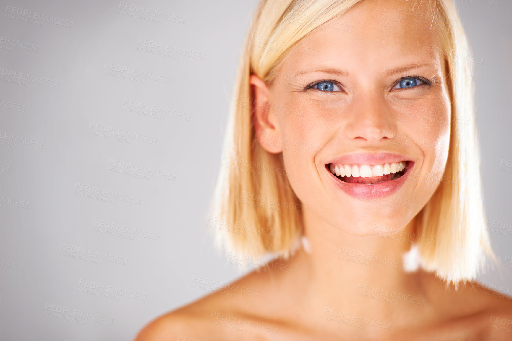 Buy stock photo Portrait of a pretty young woman with a large grin and copyspace beside her