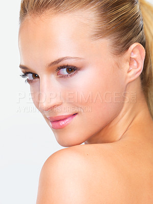 Buy stock photo Closeup portrait of a beautiful blonde woman with flawless skin gazing at you over her shoulder, isolated on white