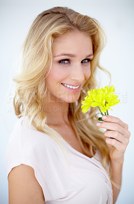 Buy stock photo Portrait of a pretty young woman holding a yellow flower - Isolated on white