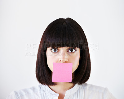 Buy stock photo Conceptual image of a young businesswoman with a pink post-it note covering her mouth