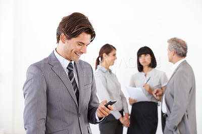 Buy stock photo Businessman, cellphone and smile or team background, job communication or online planning. Male person, mobile decisions and internet company connection or conversation, text or colleague networking