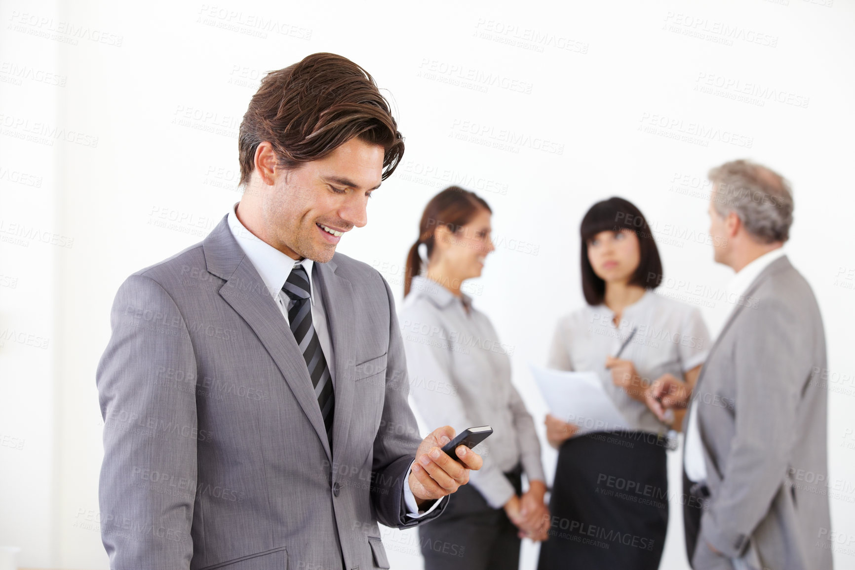Buy stock photo Businessman, cellphone and smile or team background, job communication or online planning. Male person, mobile decisions and internet company connection or conversation, text or colleague networking