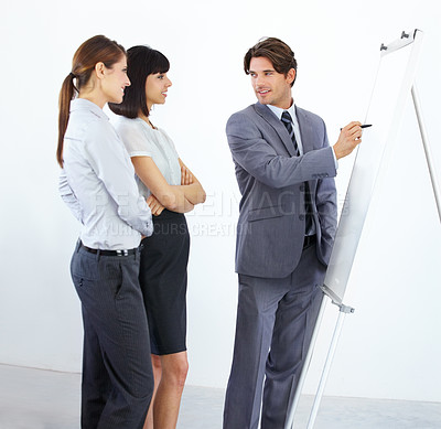 Buy stock photo Businessman, writing and coaching on whiteboard for planning, strategy or collaboration at the office. Business people in brainstorming, schedule or training staff in presentation at the workplace