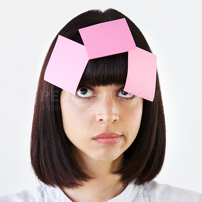 Buy stock photo Sticky notes on face of woman thinking in studio with planning, daydreaming or idea. Wonder, contemplating and pensive female model with paper on her head for solution isolated by a white background.