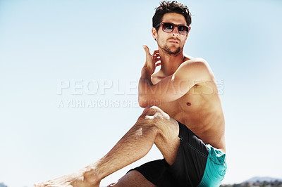 Buy stock photo Sunglasses, beach and man relax on holiday, vacation or travel for tropical tourism on a blue sky mockup space. Summer, serious person in swimwear and sunbathe outdoor, fashion style and thinking