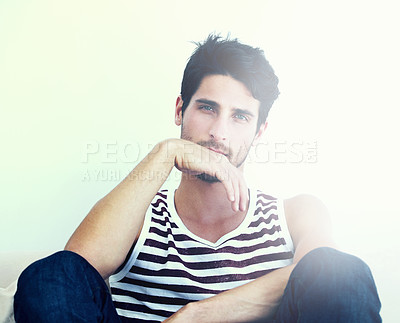 Buy stock photo Portrait of a striking young man sitting down with his hand to his mouth - Copyspace