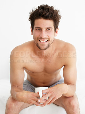 Buy stock photo Portrait of a handsome male sitting in his underwear drinking a cup of coffee/tea