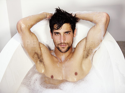Buy stock photo Sexy portrait of a young handsome male relaxing in a bath tub of bubble bath
