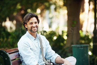 Buy stock photo Travel, relax and portrait of a man on a park bench for a break, morning commute or summer. Smile, nature and a young person or tourist in a public garden for tourism, sightseeing or a vacation