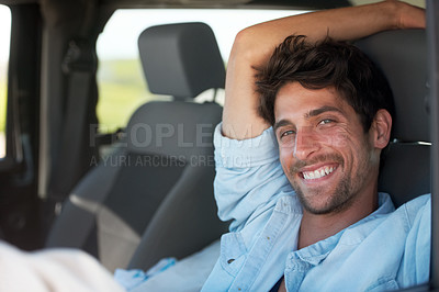 Buy stock photo A young man enjoying his vacation road trip with a smile