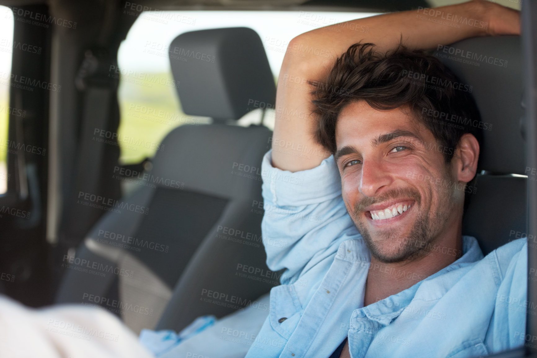 Buy stock photo A young man enjoying his vacation road trip with a smile